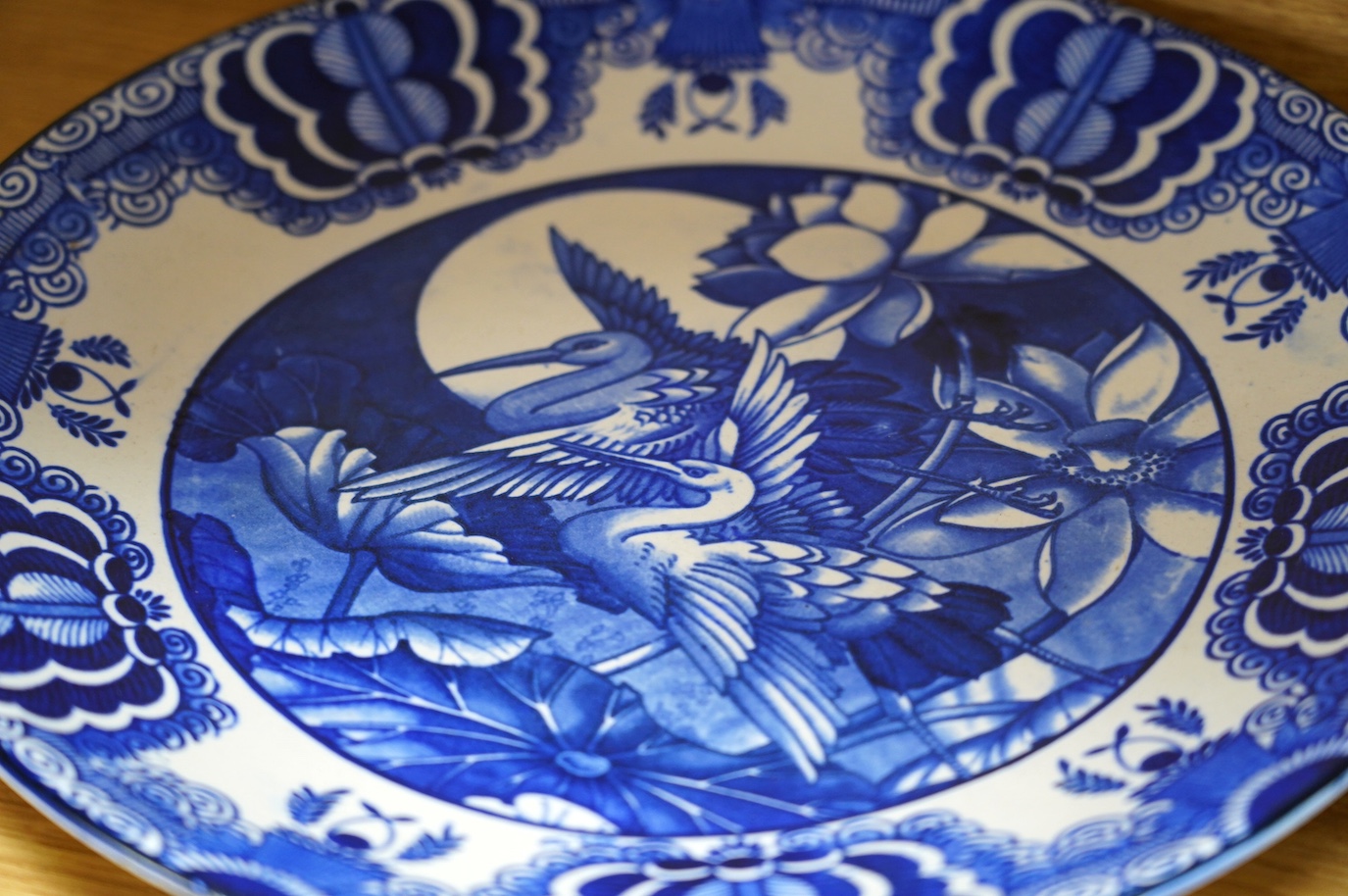 Two Charlotte Rhead signed chargers, a similar signed matching plate and vase and a ‘Mikado’ Burslem blue and white Oriental style charger designed by Frederick Rhead, largest 45cm diameter. Condition - good